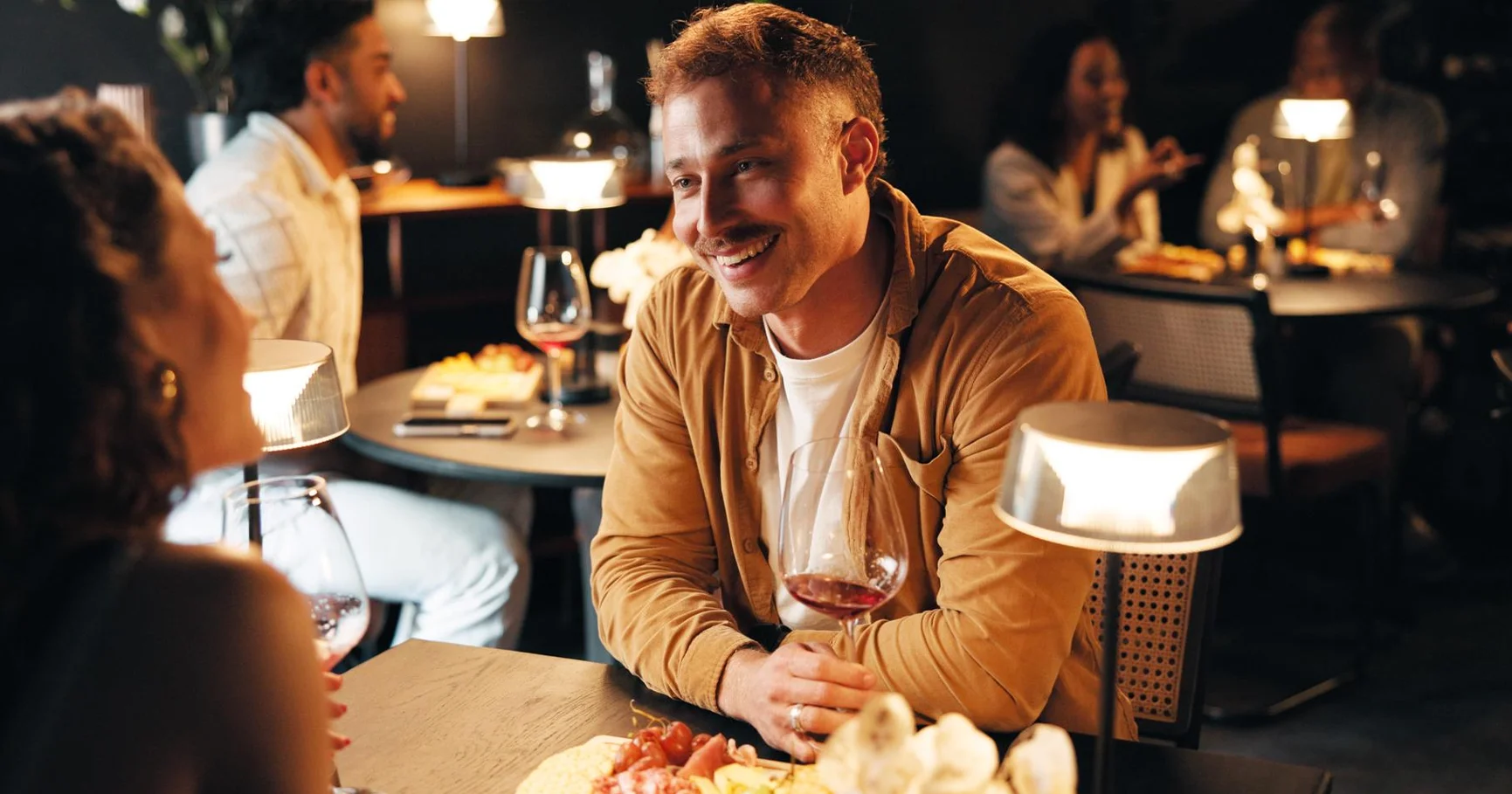 Couple enjoying dinner and wine at a romantic Montreal restaurant